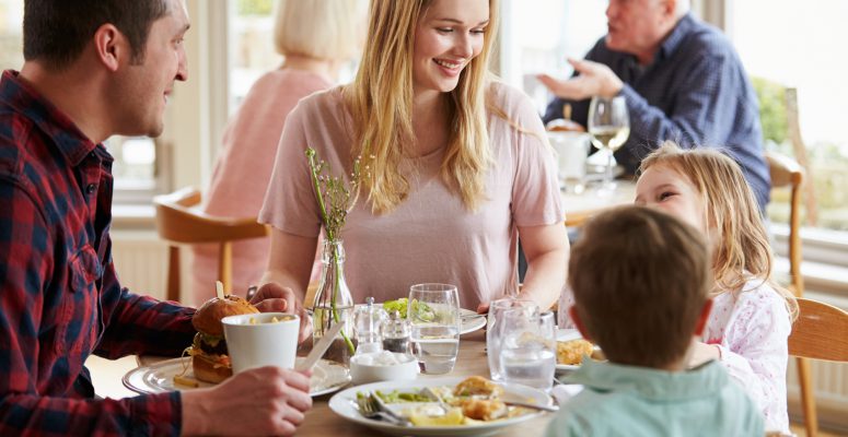 Family Enjoying Meal In Restaurant Together